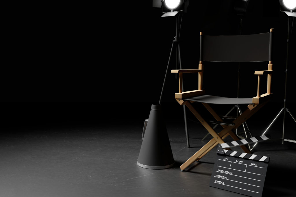 Director Chair,Megaphone,Movie Clapper and lighting equipment on dark